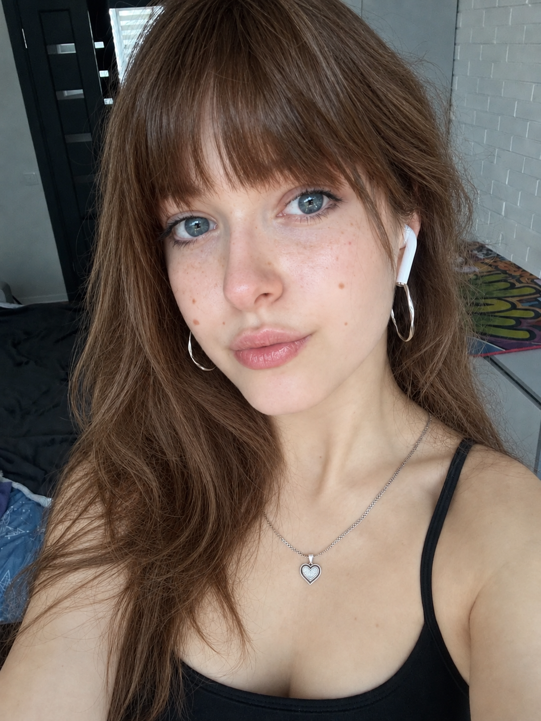 Close-up of Hannah with a fringe and an earbud